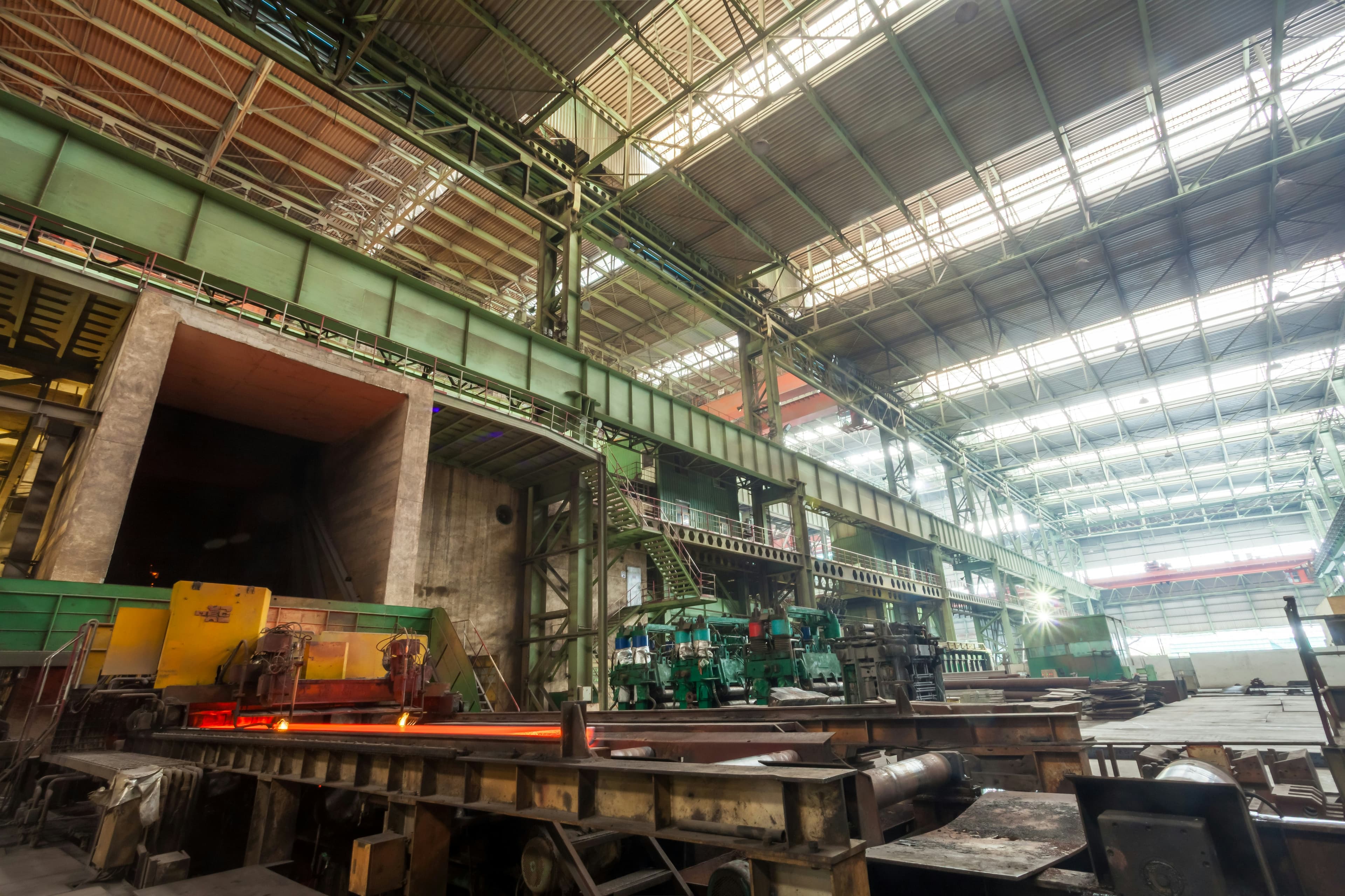 Steel mill interior showing multiple production lines and industrial machinery, symbolising complexity and the need for considered, multi-option procurement thinking.